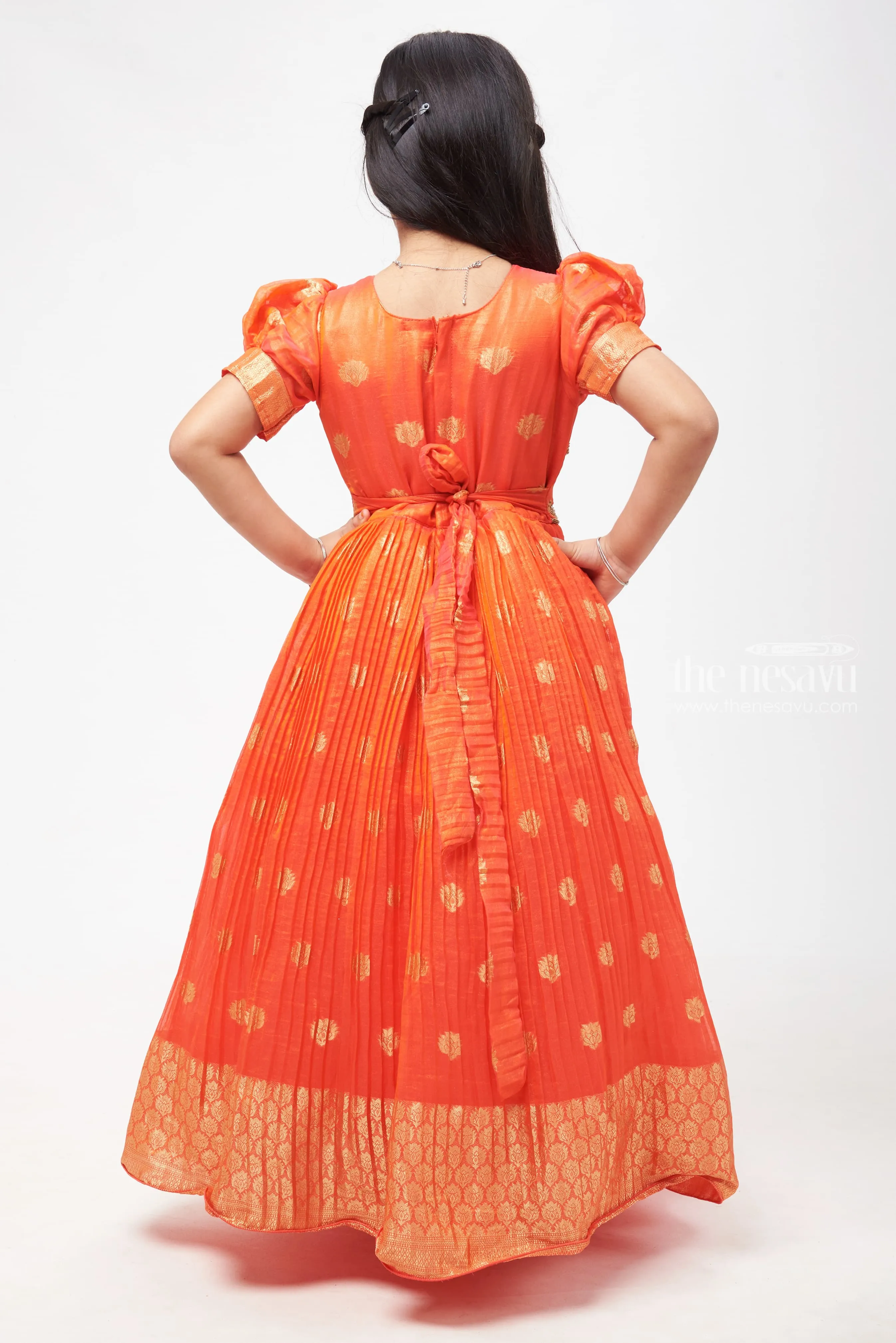 Crimson Elegance: Orange Anarkali with Gilded Accents and Tassel Detailing